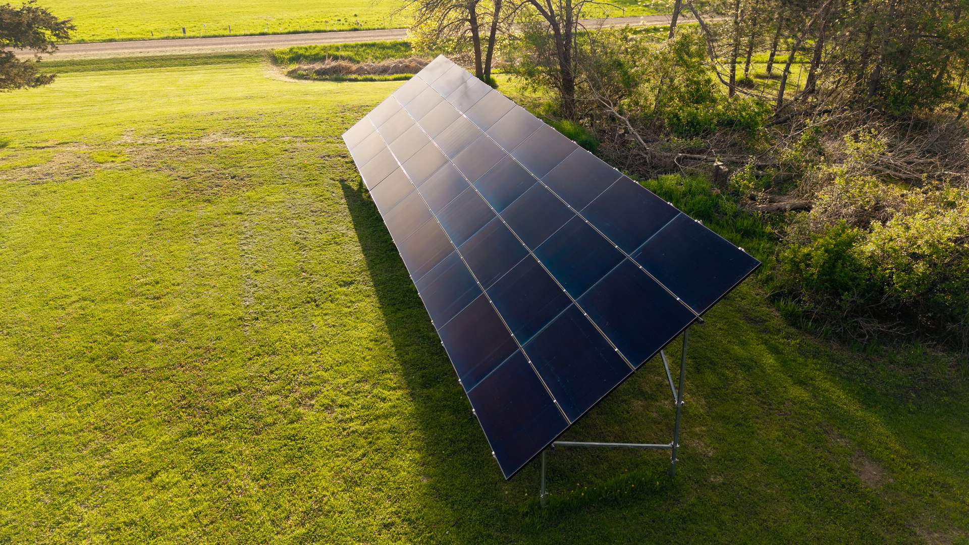 Ground-mount solar array in a green yard