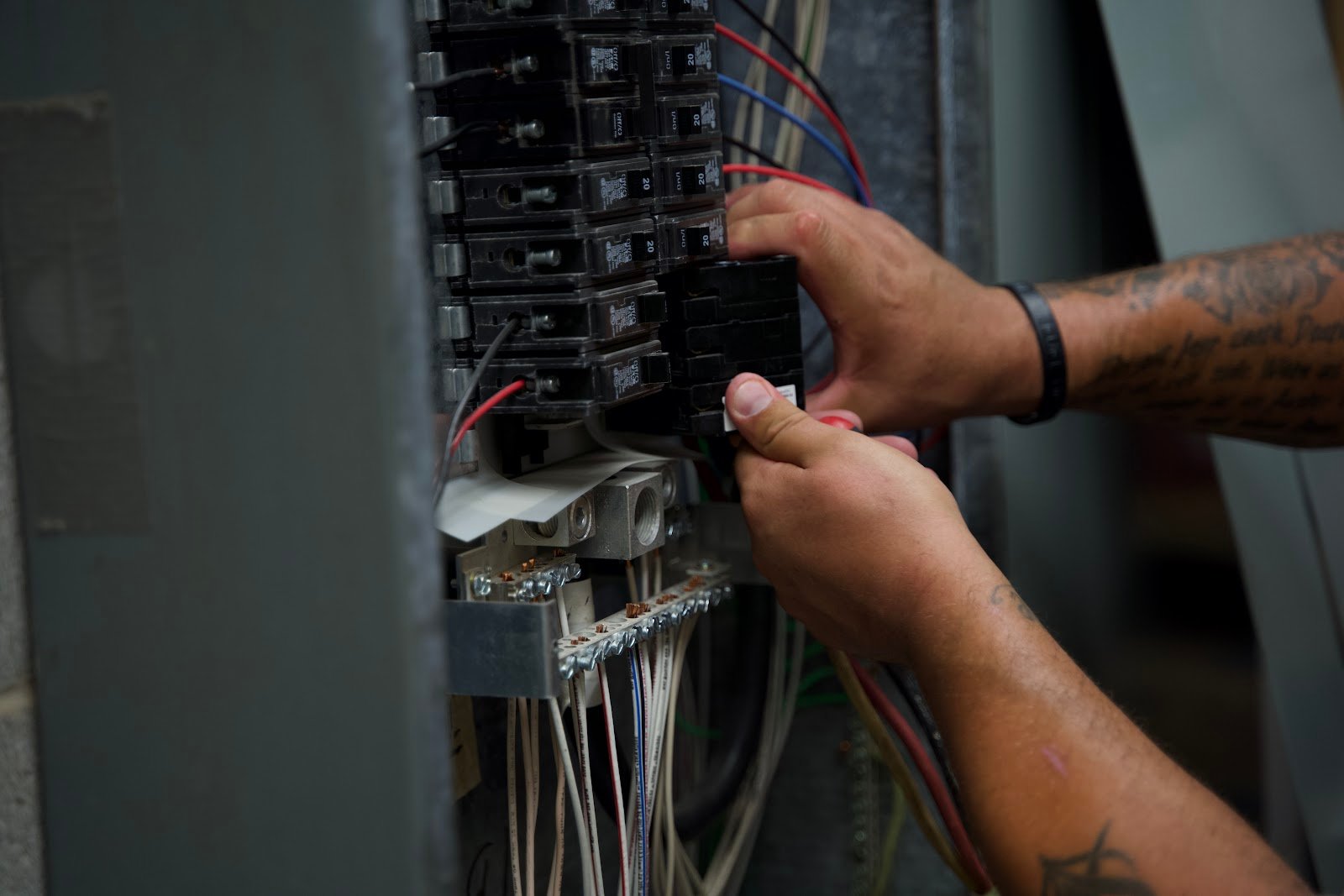 Hands terminating panel wiring, Wolf River Electric electrical work