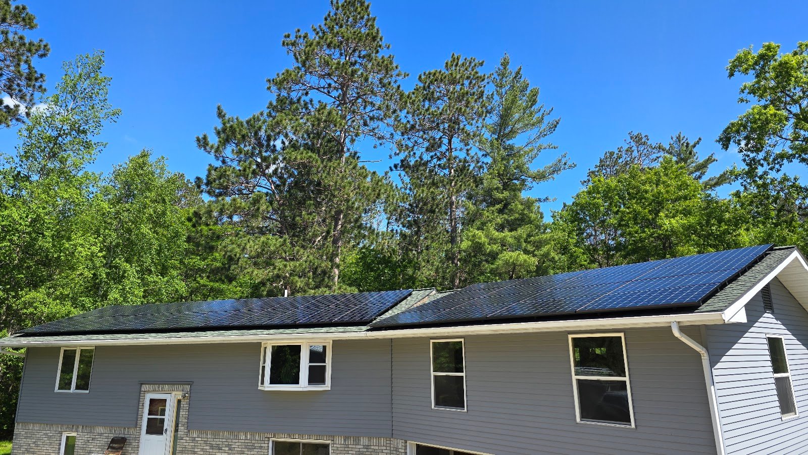Home with solar panels pines, installed by Wolf River Electric
