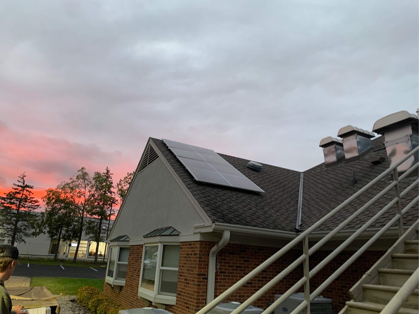 Home with solar panels sunset sky, installed by Wolf River Electric