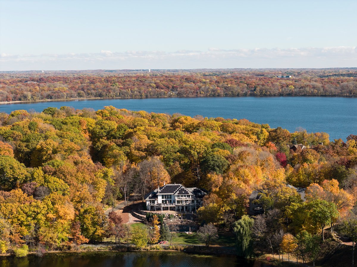 Lakeside home with rooftop solar in fall color, installed by Wolf River Electric