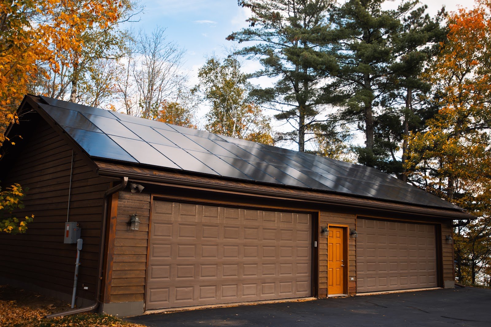 Log home garage with solar panels, installed by Wolf River Electric