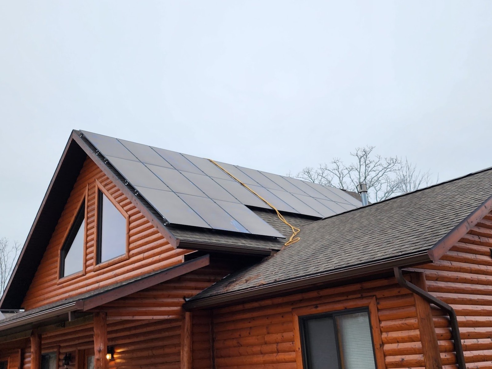 Log home metal roof solar panels, installed by Wolf River Electric