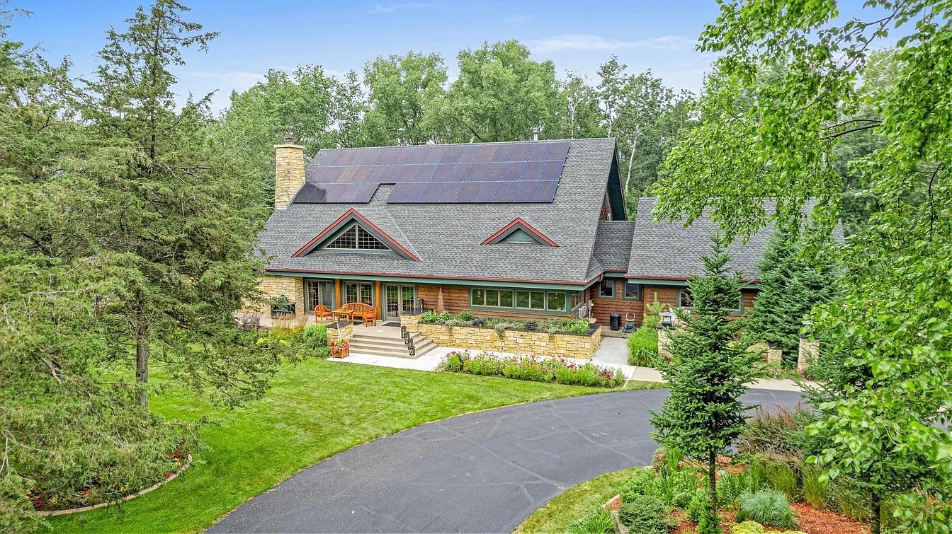 Log home with solar panels, installed by Wolf River Electric