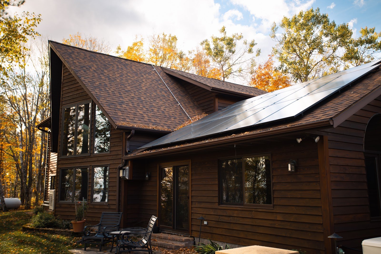 Log home with solar panels, installed by Wolf River Electric