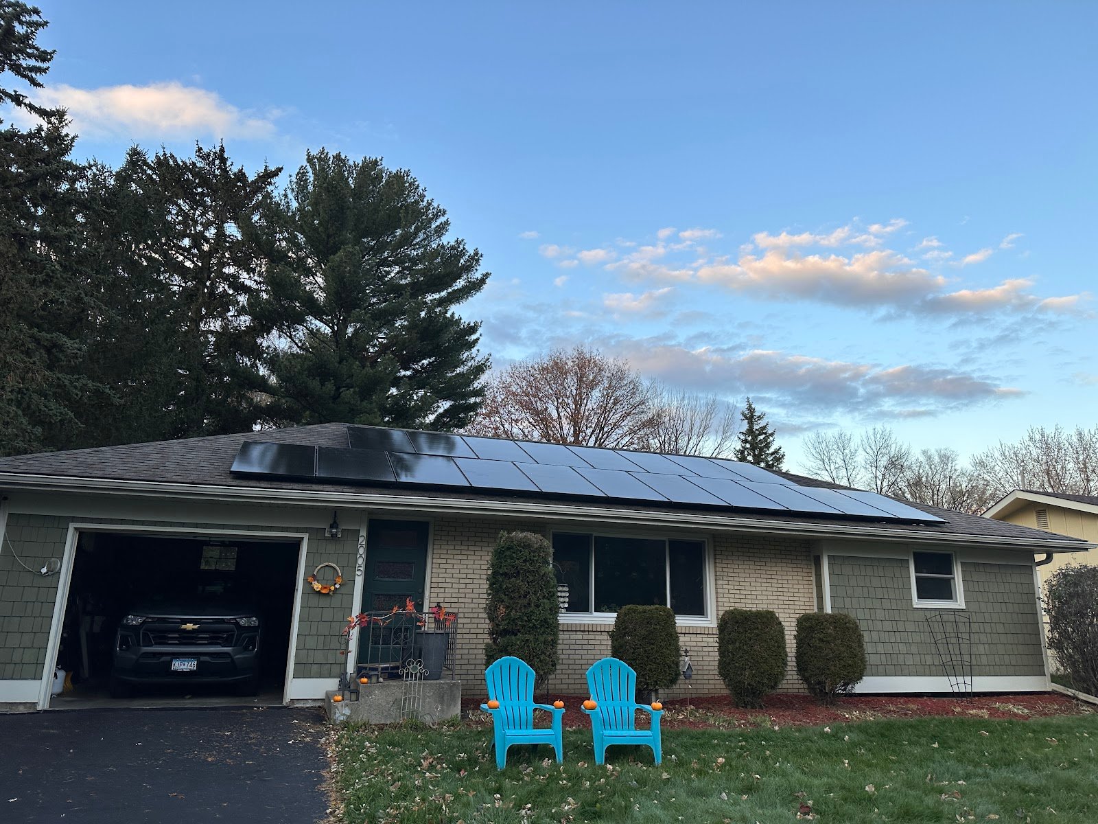 Ranch home with solar panels lawn chairs, installed by Wolf River Electric