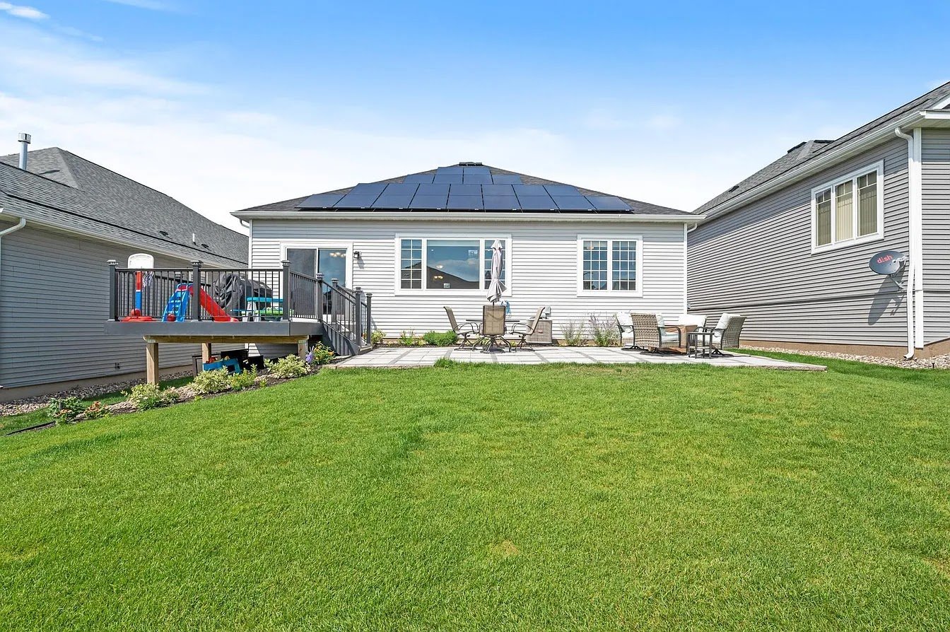 Ranch home with solar panels lawn, installed by Wolf River Electric