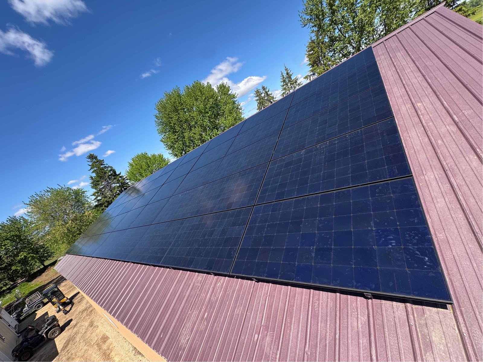 Red metal roof solar panels, installed by Wolf River Electric