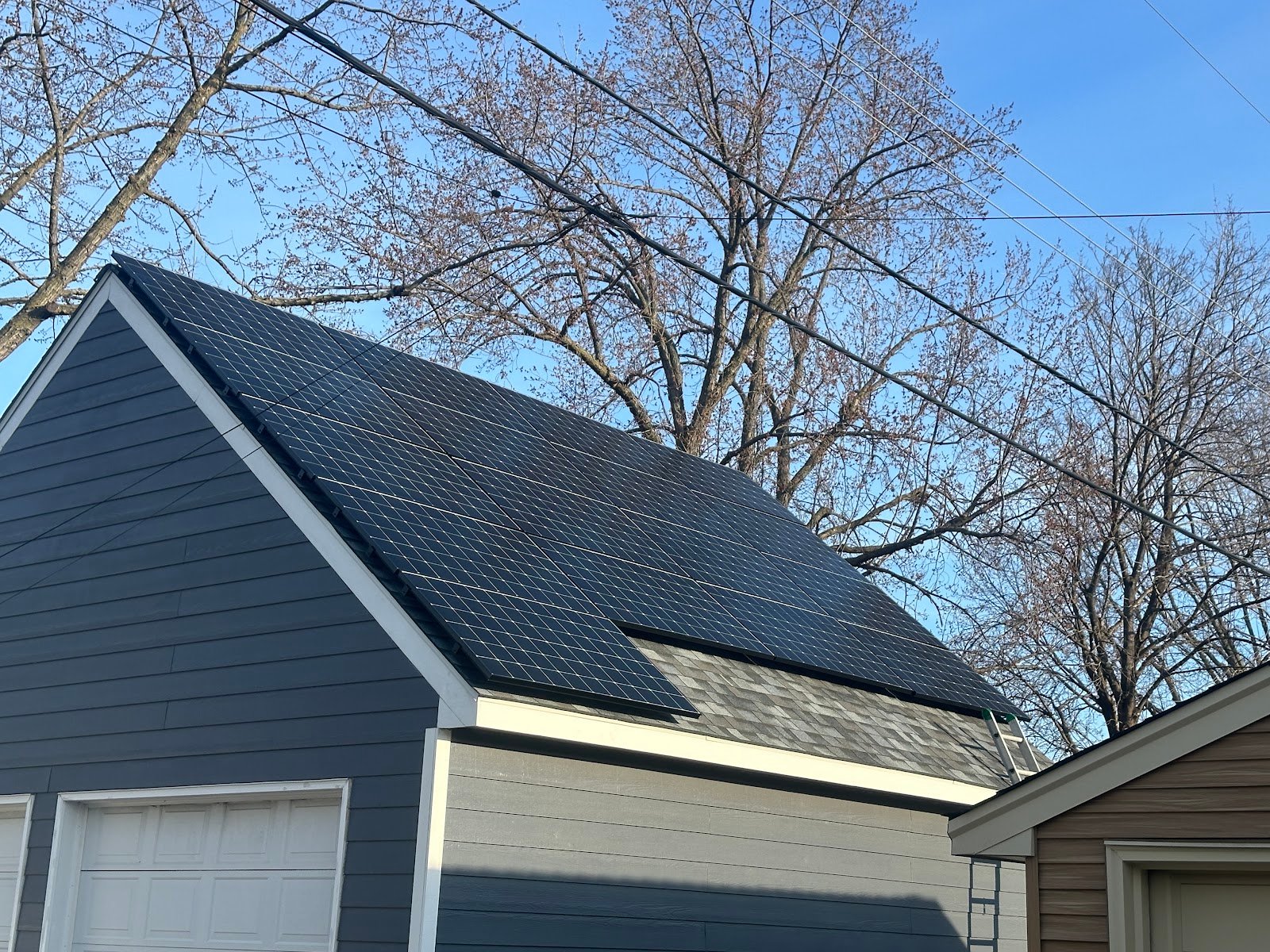 Roof solar panels blue home, installed by Wolf River Electric