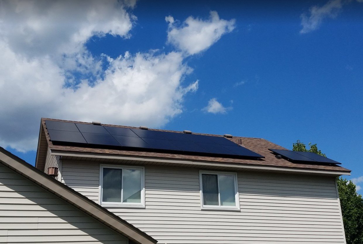 Roof solar panels blue sky, installed by Wolf River Electric