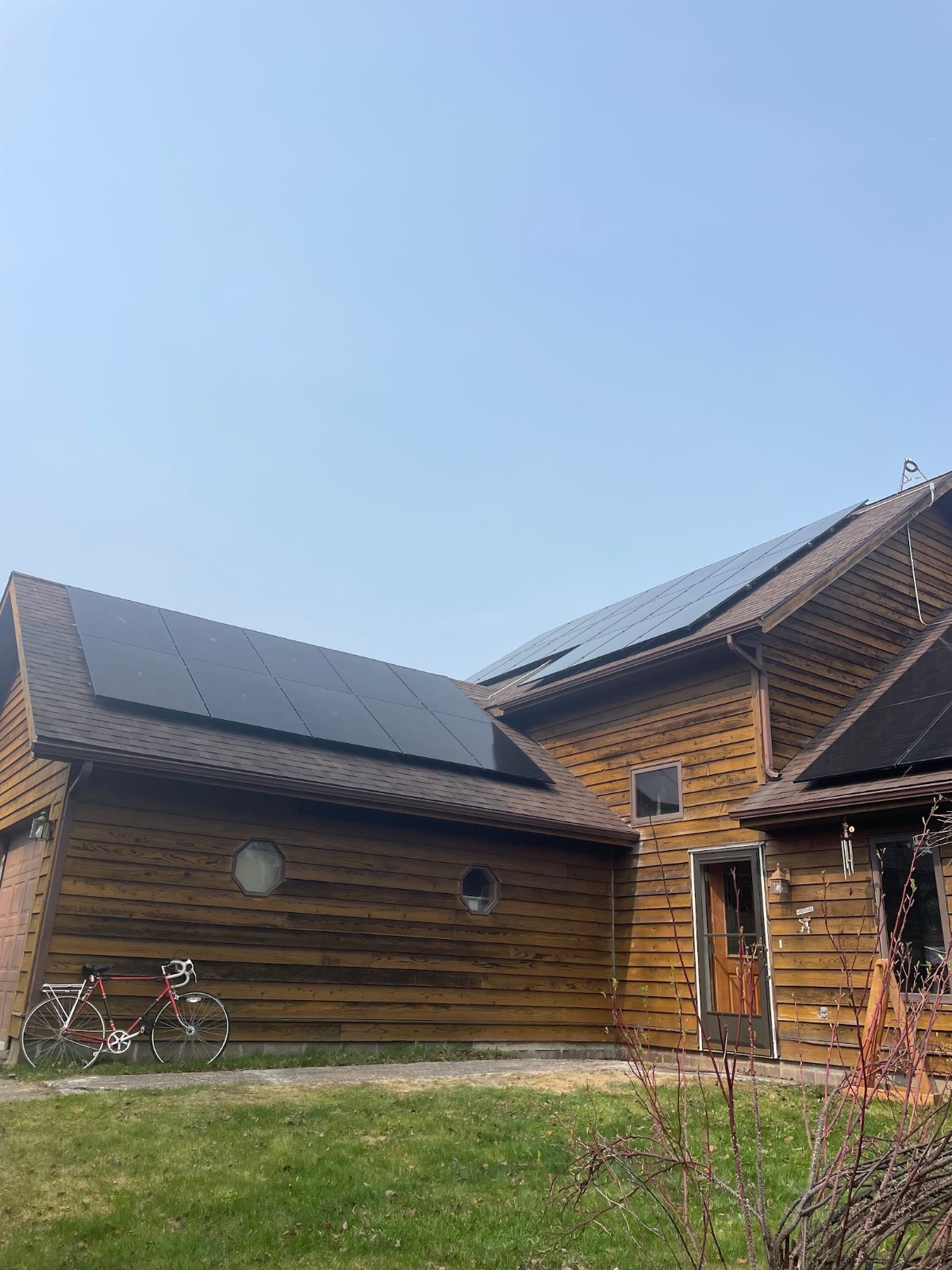 Roof solar panels cedar siding, installed by Wolf River Electric