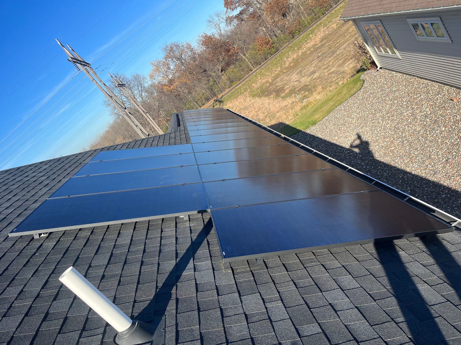 Roof solar panels pond view, installed by Wolf River Electric
