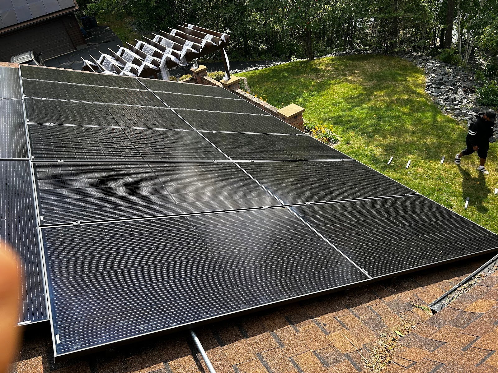 Roof solar panels rows grass, installed by Wolf River Electric