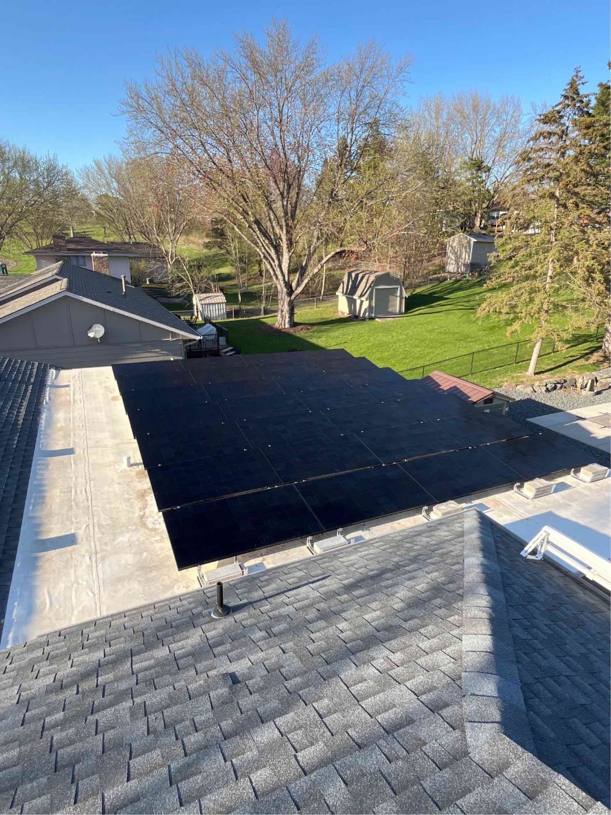 Roof solar panels wooded lot, installed by Wolf River Electric
