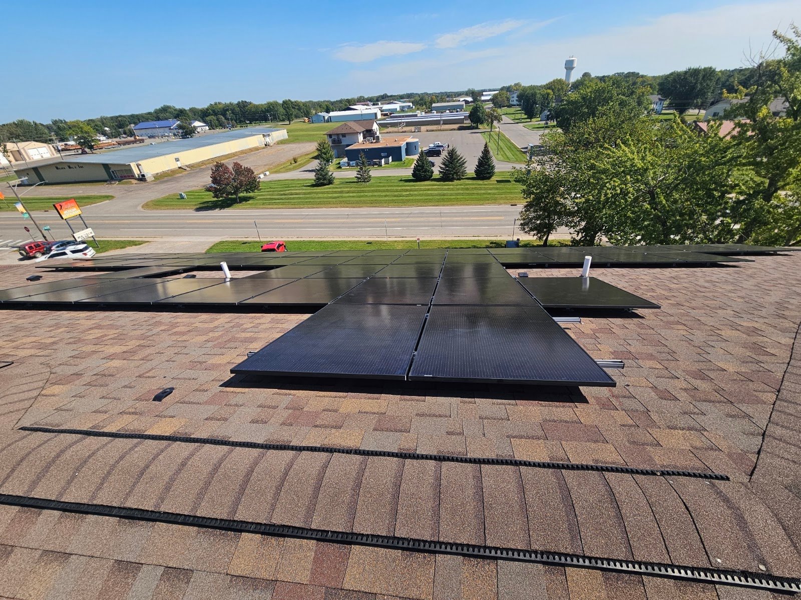 Shingle building roof solar panels, installed by Wolf River Electric