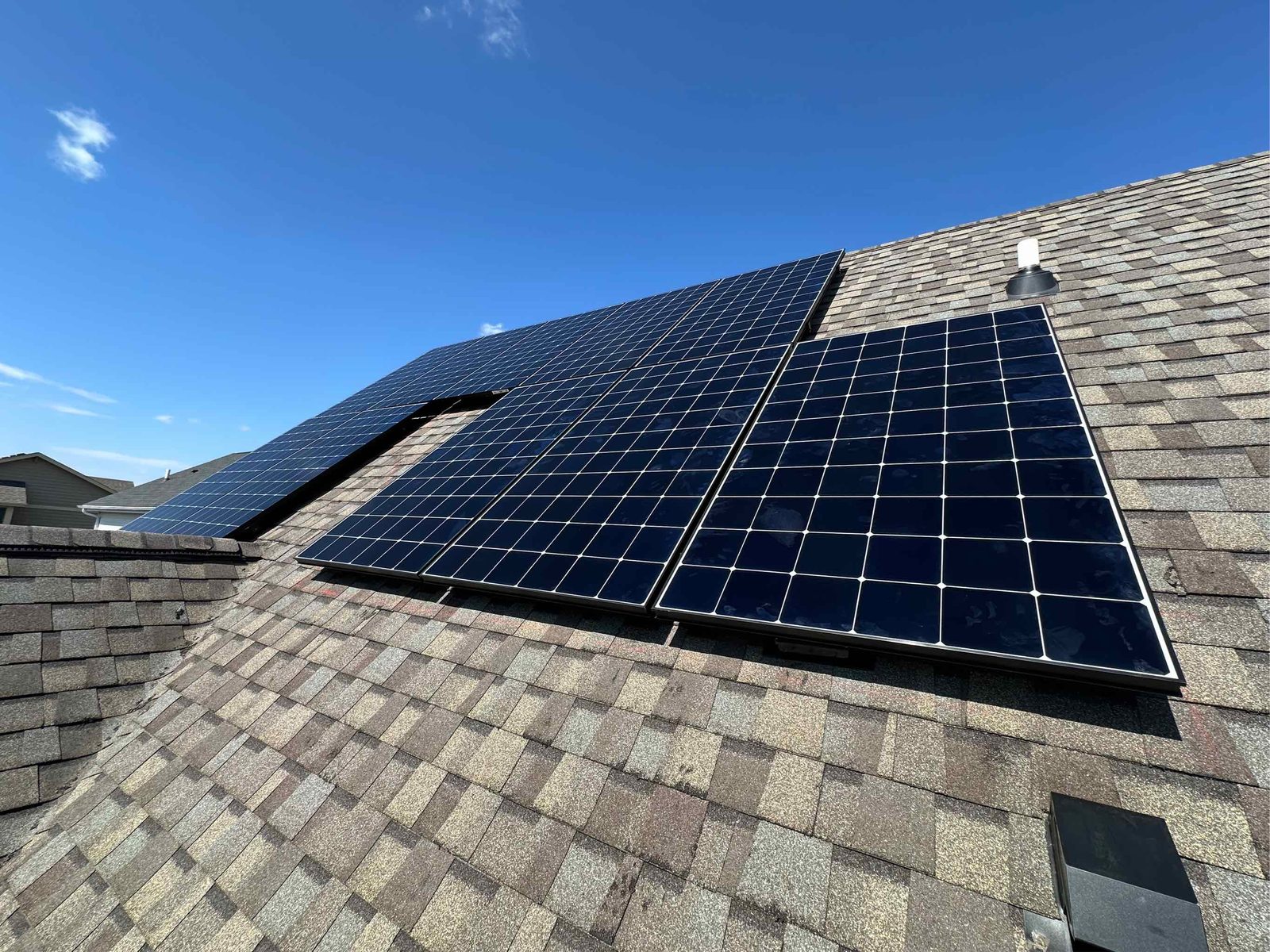 Solar array under blue sky, installed by Wolf River Electric