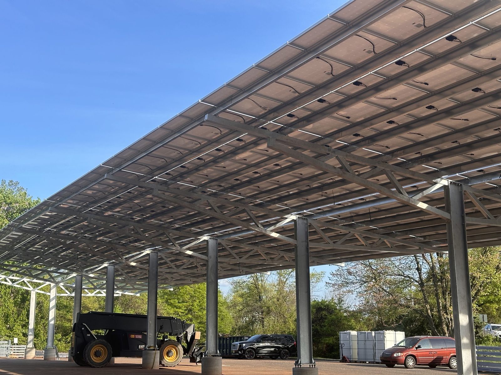 Solar carport shading parked cars, installed by Wolf River Electric