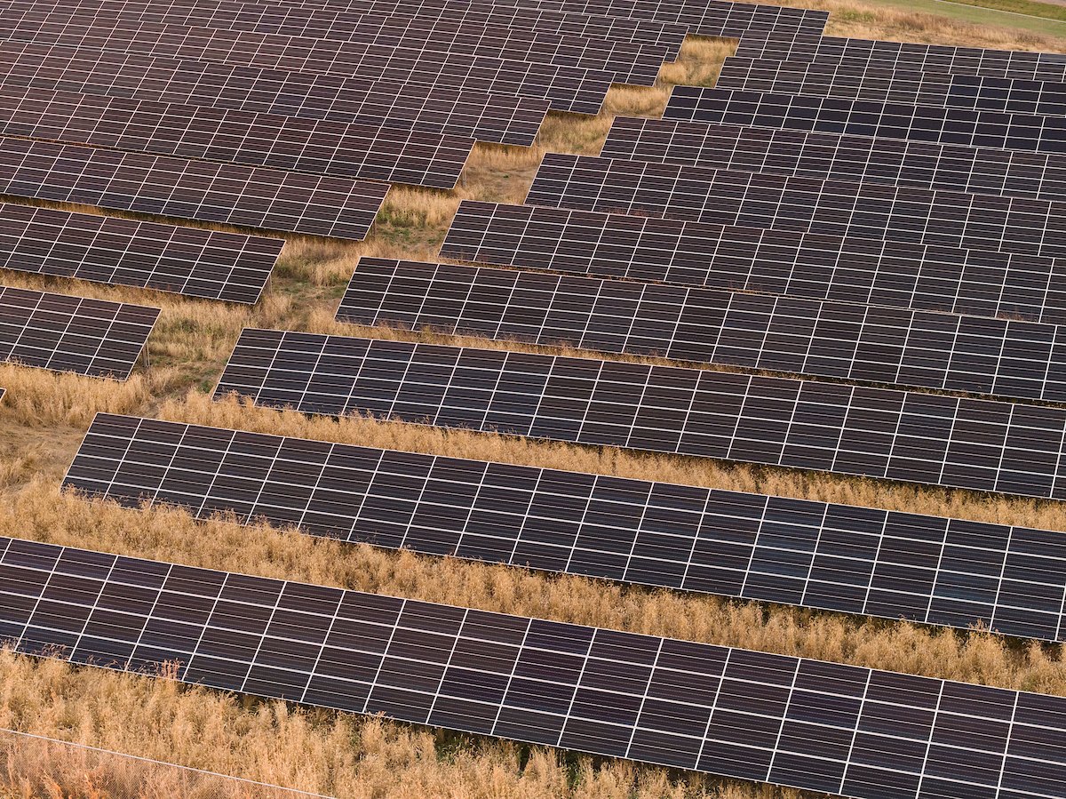Close aerial view of solar farm rows, installed by Wolf River Electric