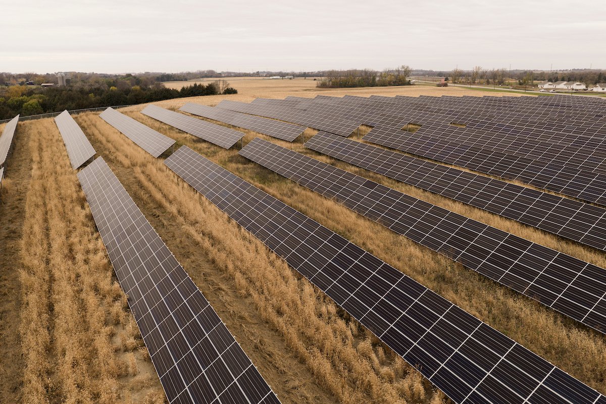 Solar farm rows stretching across a field, installed by Wolf River Electric