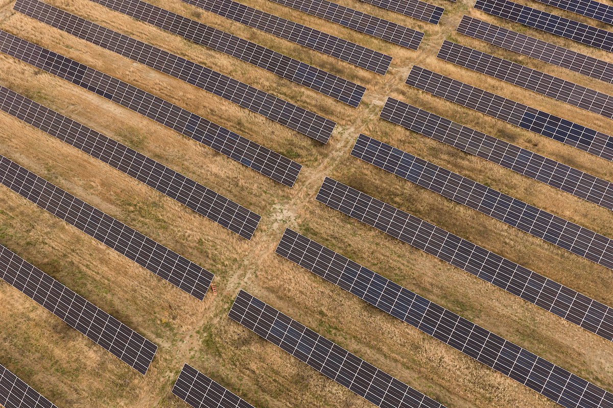 Top-down aerial view of solar farm rows, installed by Wolf River Electric