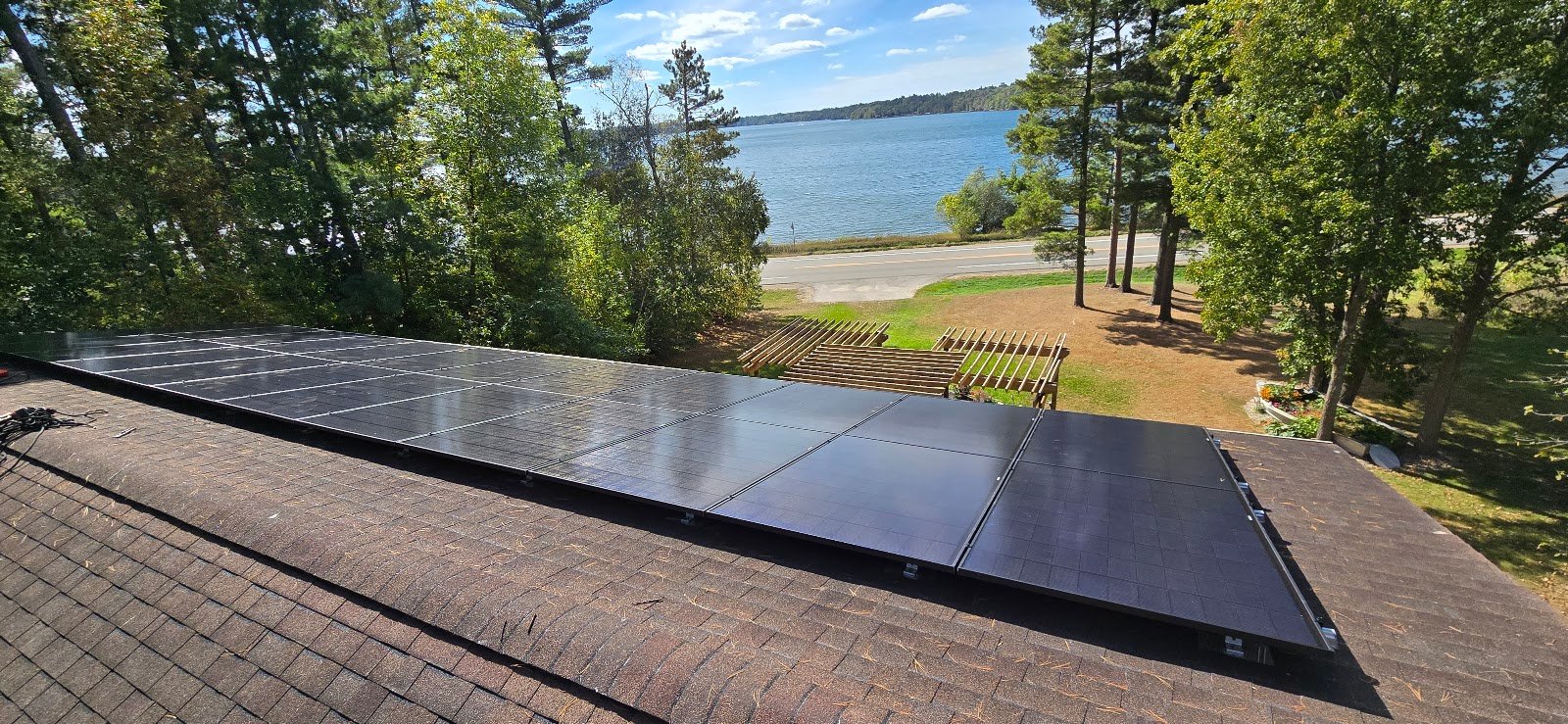 Solar panels lakeside, installed by Wolf River Electric