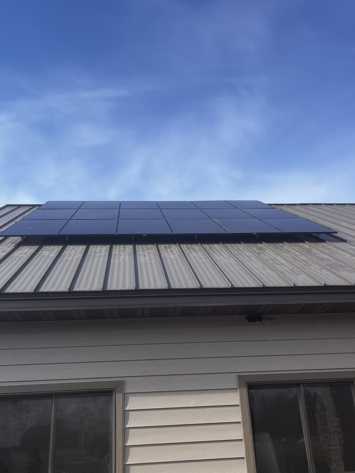 Solar panels on metal roof home, installed by Wolf River Electric