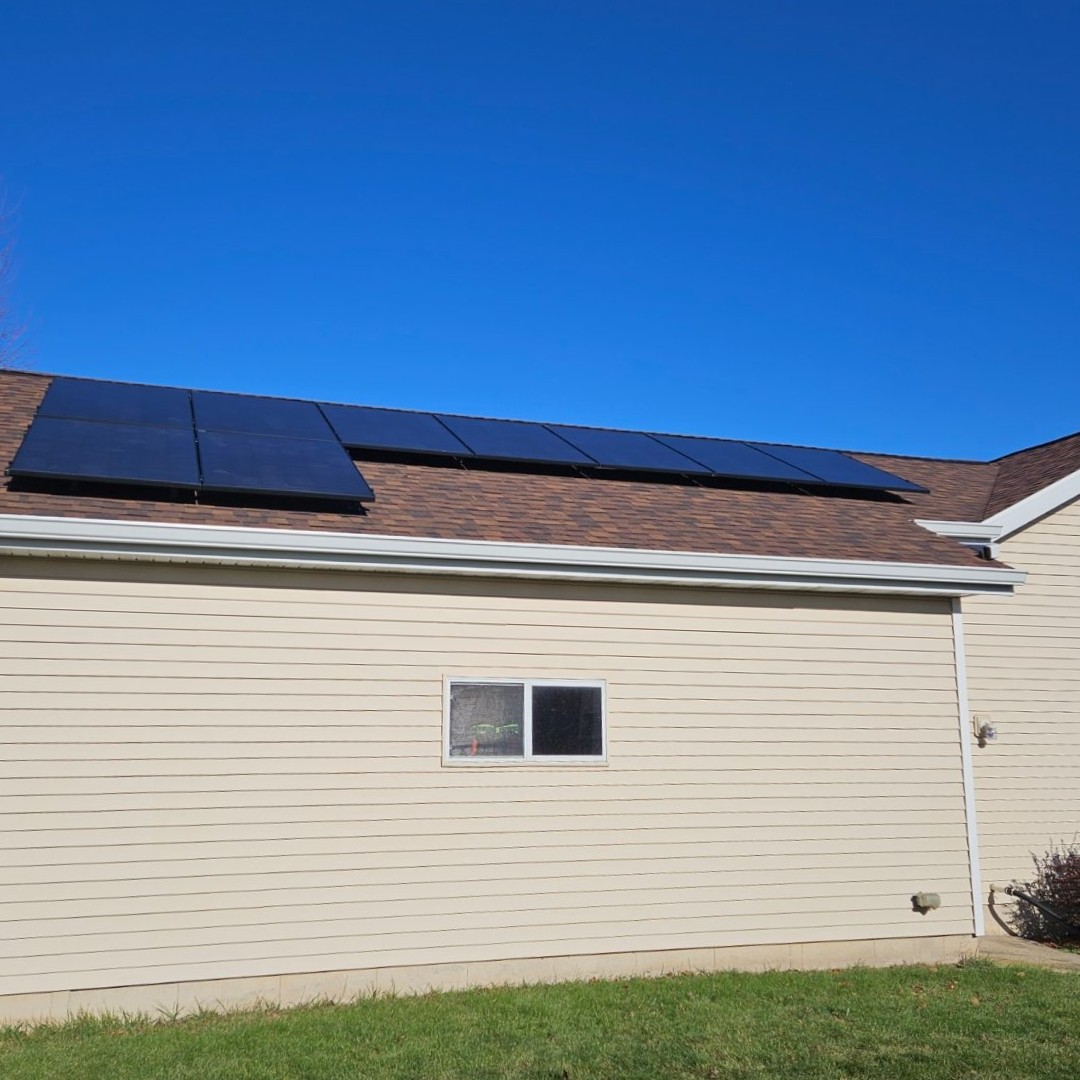 Tan home with solar on roof, installed by Wolf River Electric