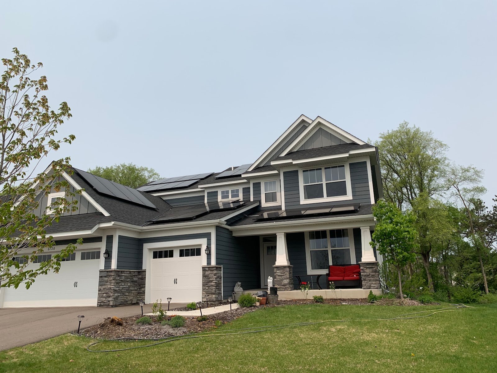 Two story home with solar panels, installed by Wolf River Electric