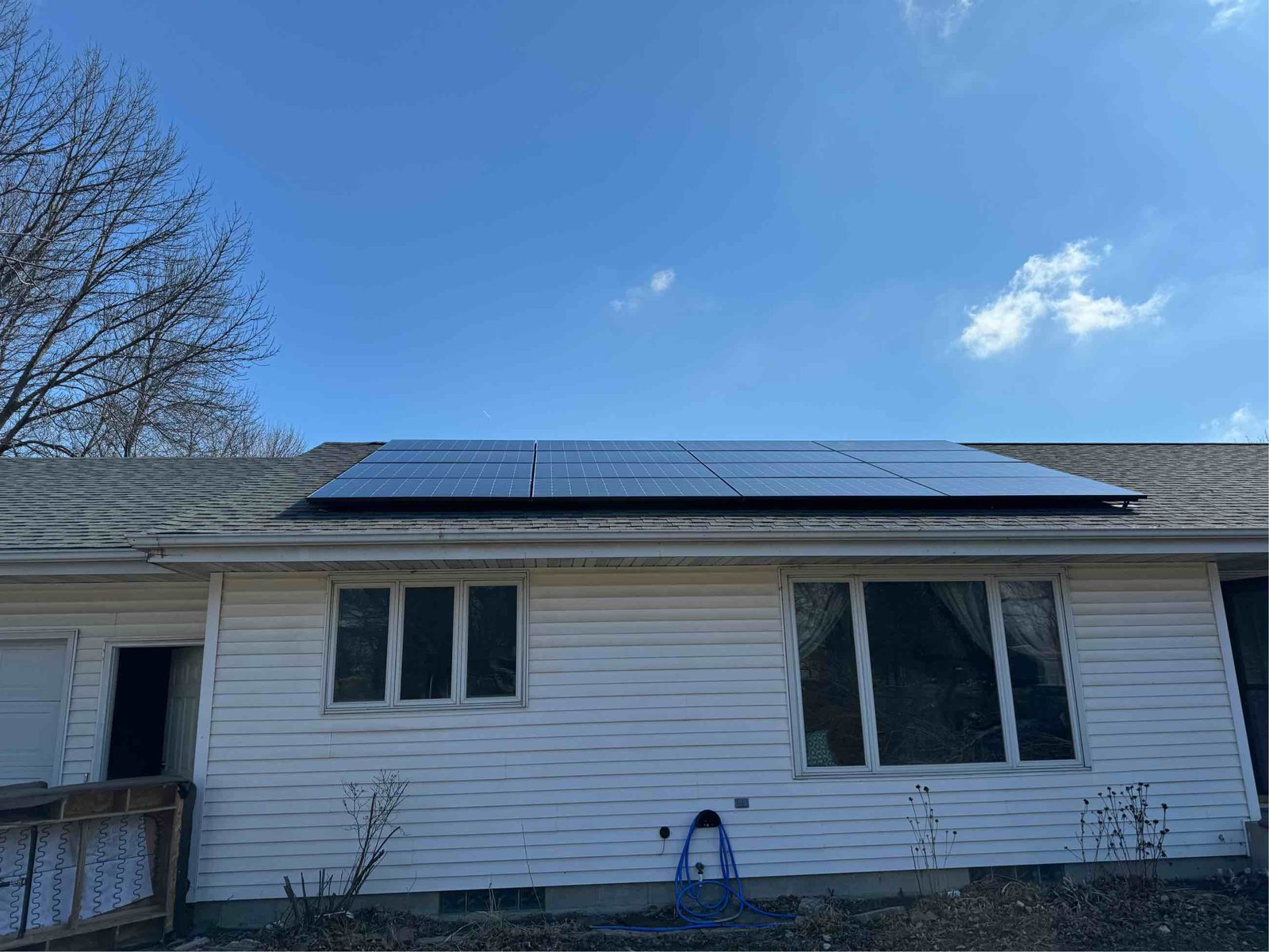 White home with solar on roof, installed by Wolf River Electric