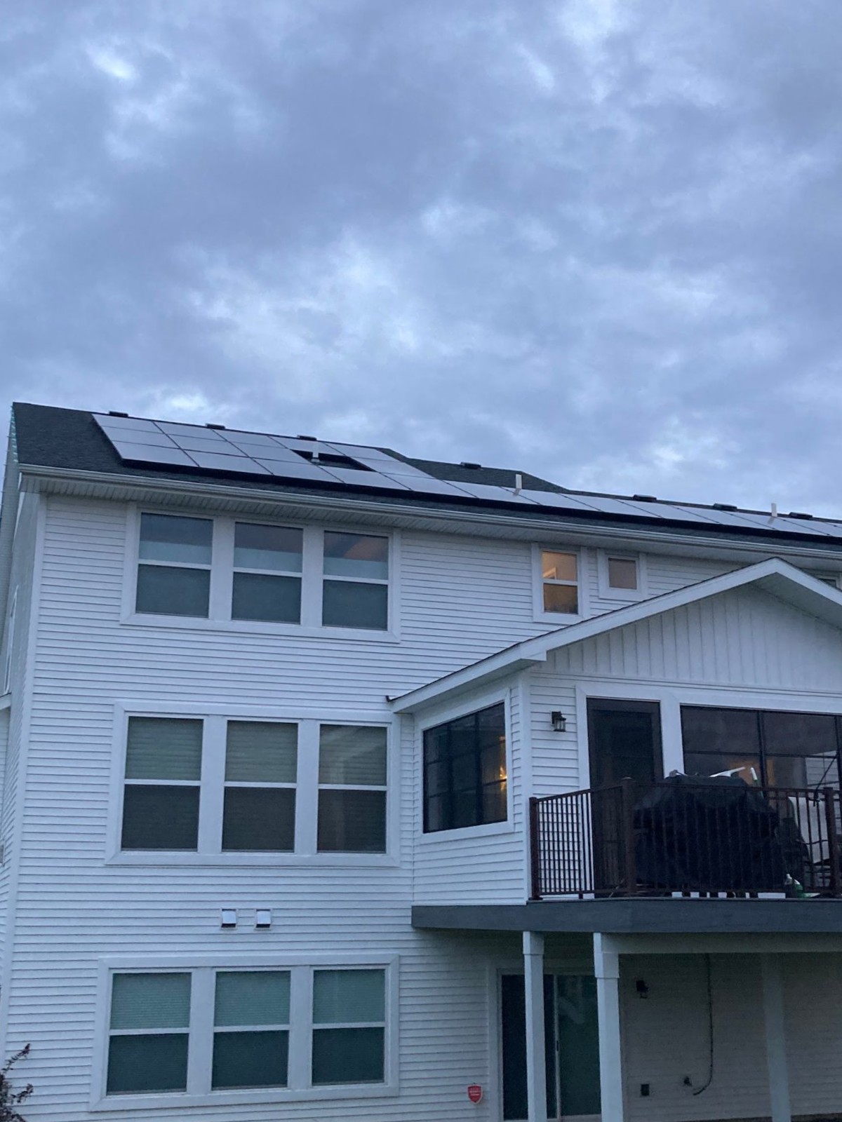 White two story home with solar panels, installed by Wolf River Electric