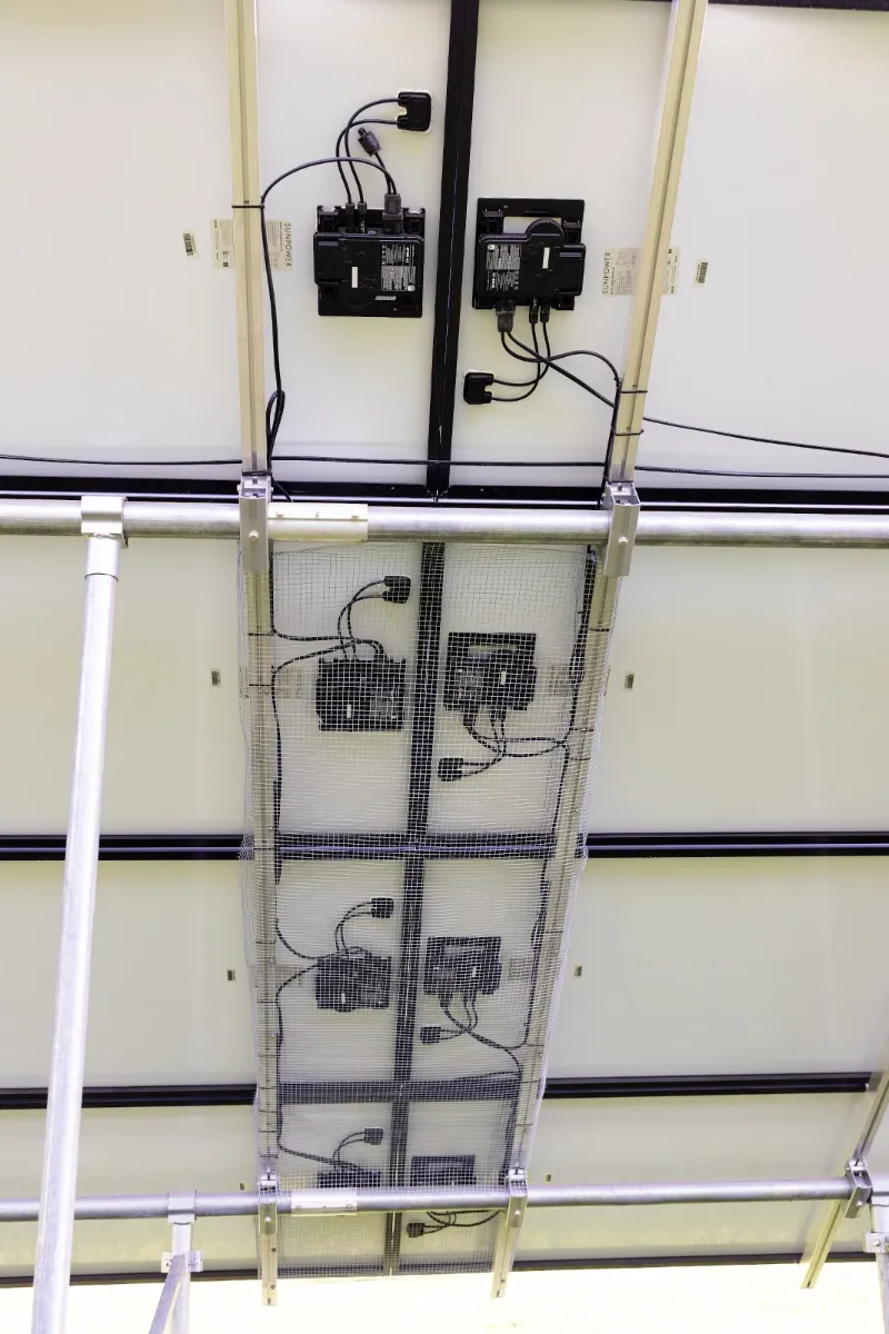 Wiring and microinverters behind a solar array, Wolf River Electric electrical work